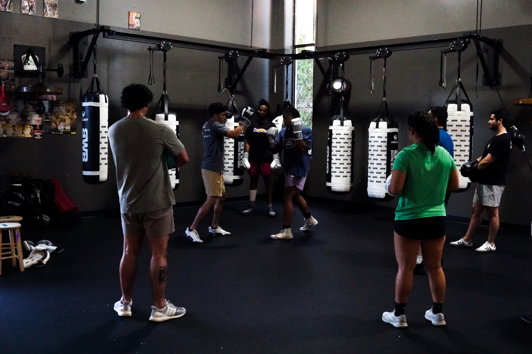 Full class working the BWB heavy-bag wall in symmetric formation