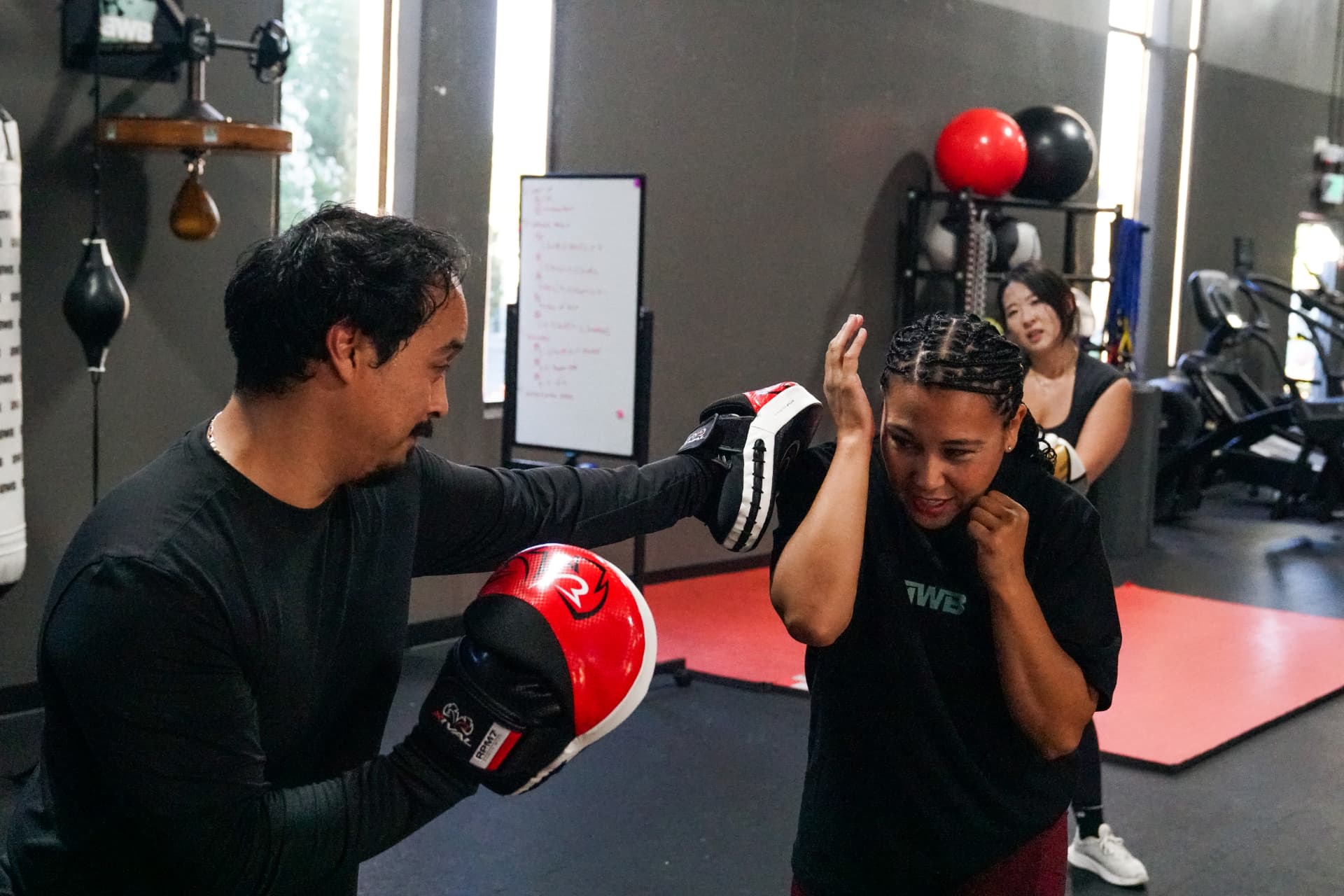 Coach Mary Ann working defensive mitts with Coach Bakr