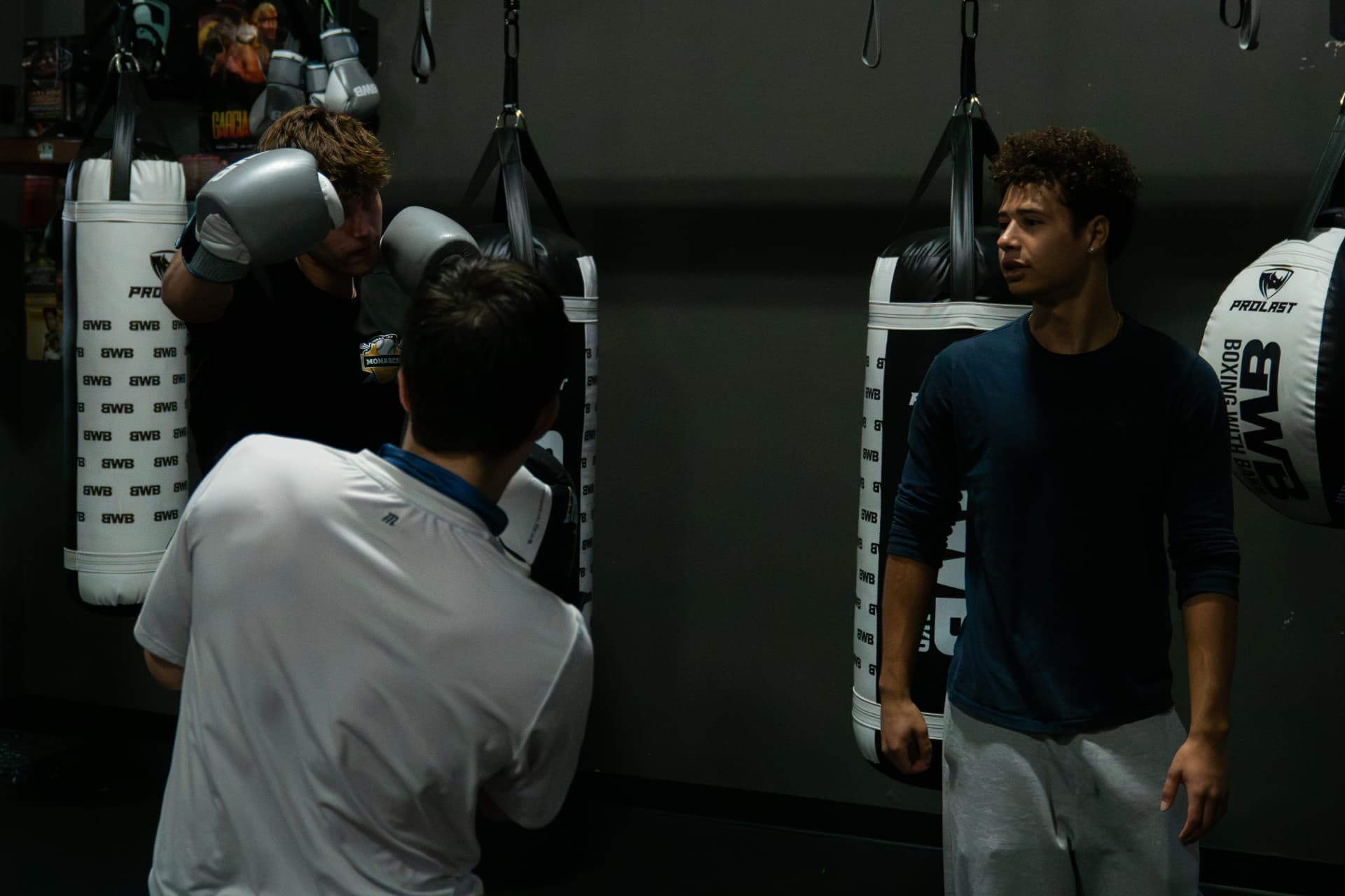 Coach Devin between rounds on the BWB heavy-bag wall