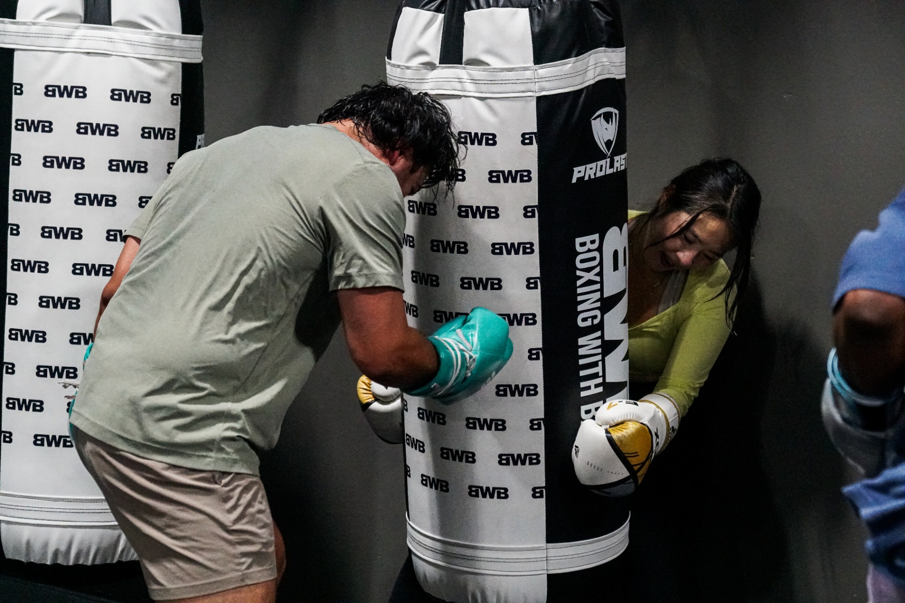Two fighters digging into shared bagwork at BWB