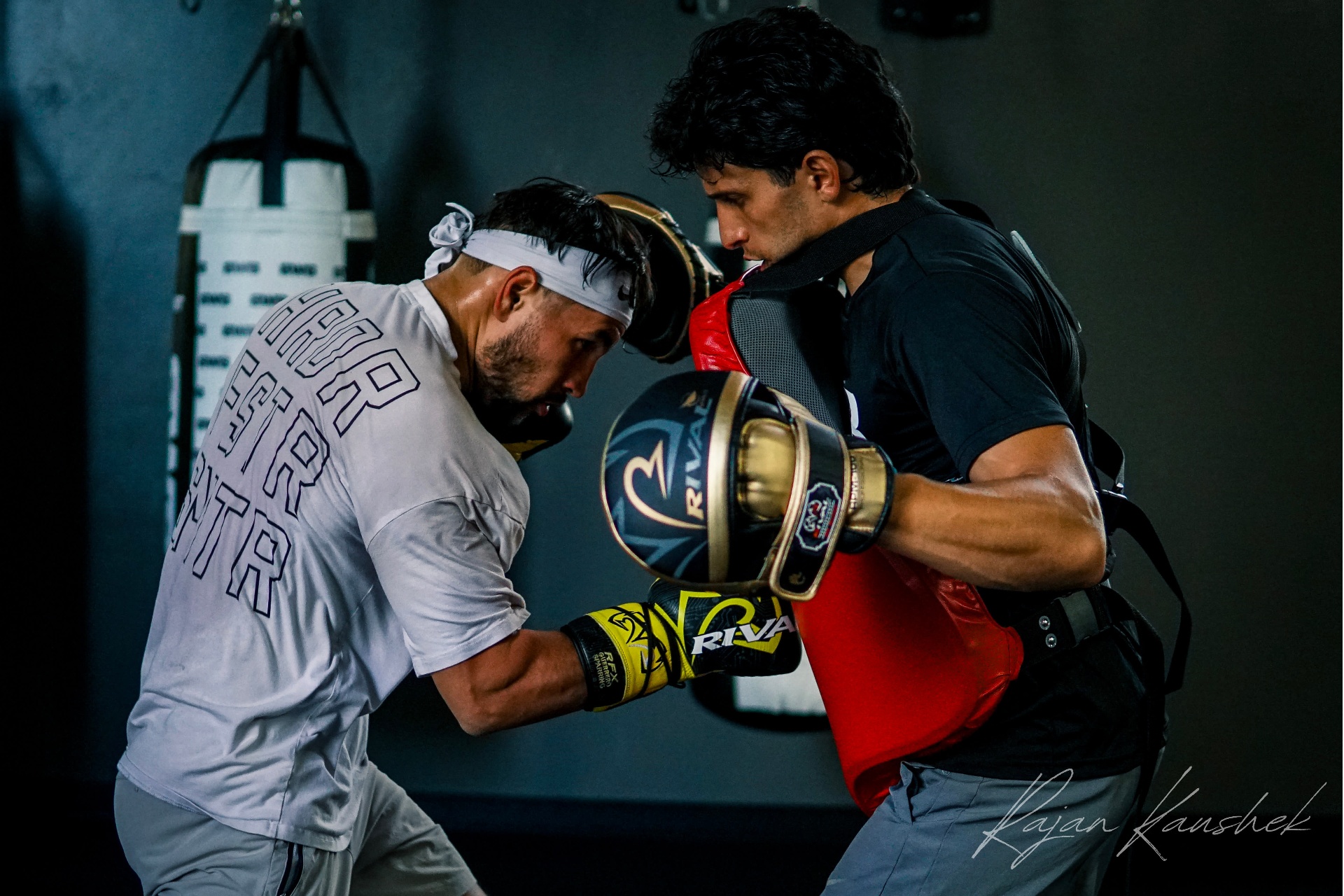 Coach Bakr on the mitts with Charlie Sheehy, head-to-head in the pocket