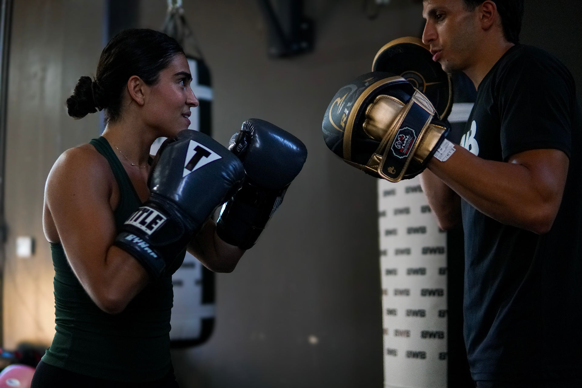 Coach Bella in close, working pads in the pocket