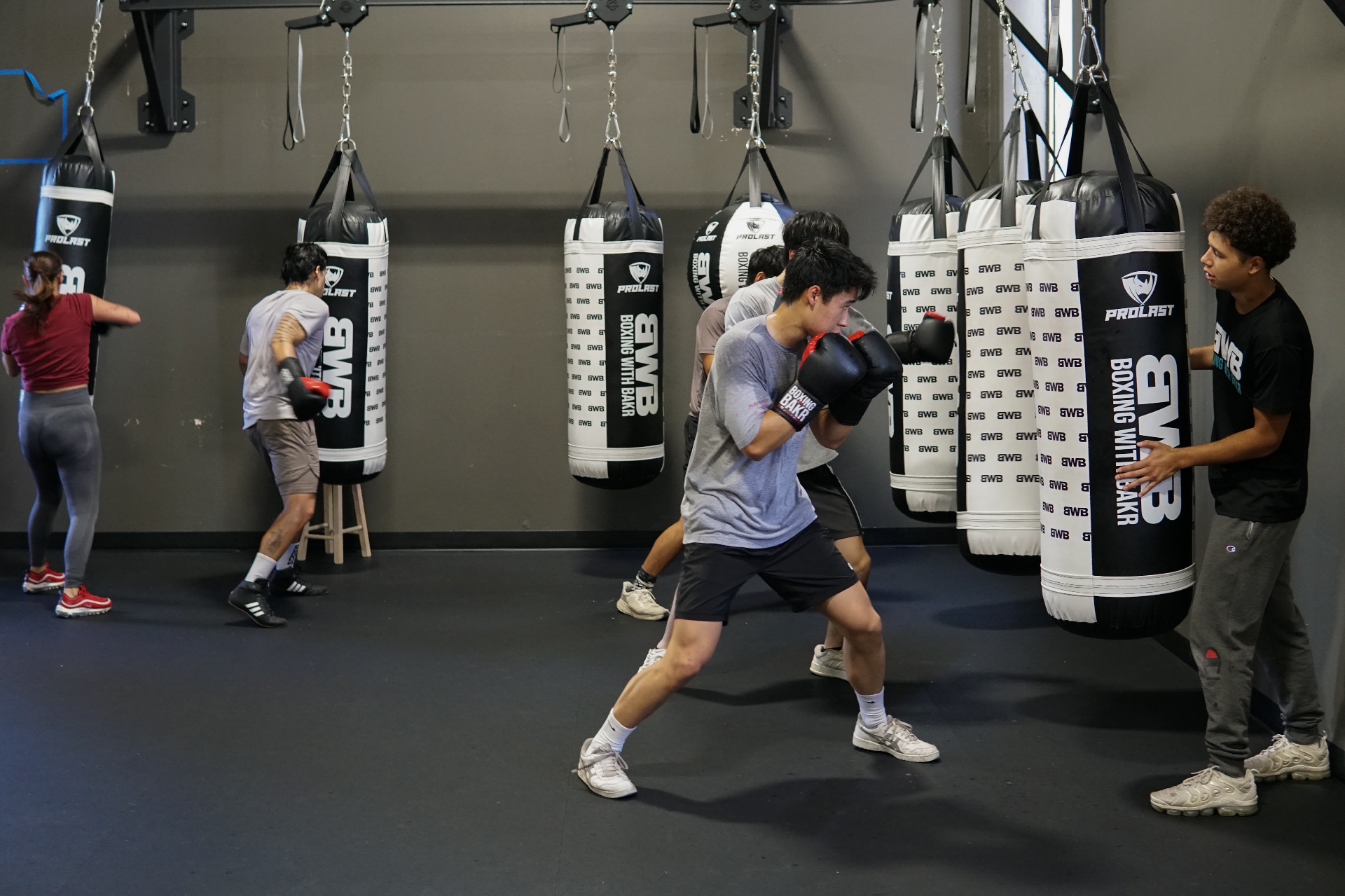 Youth class working the BWB heavy-bag wall together