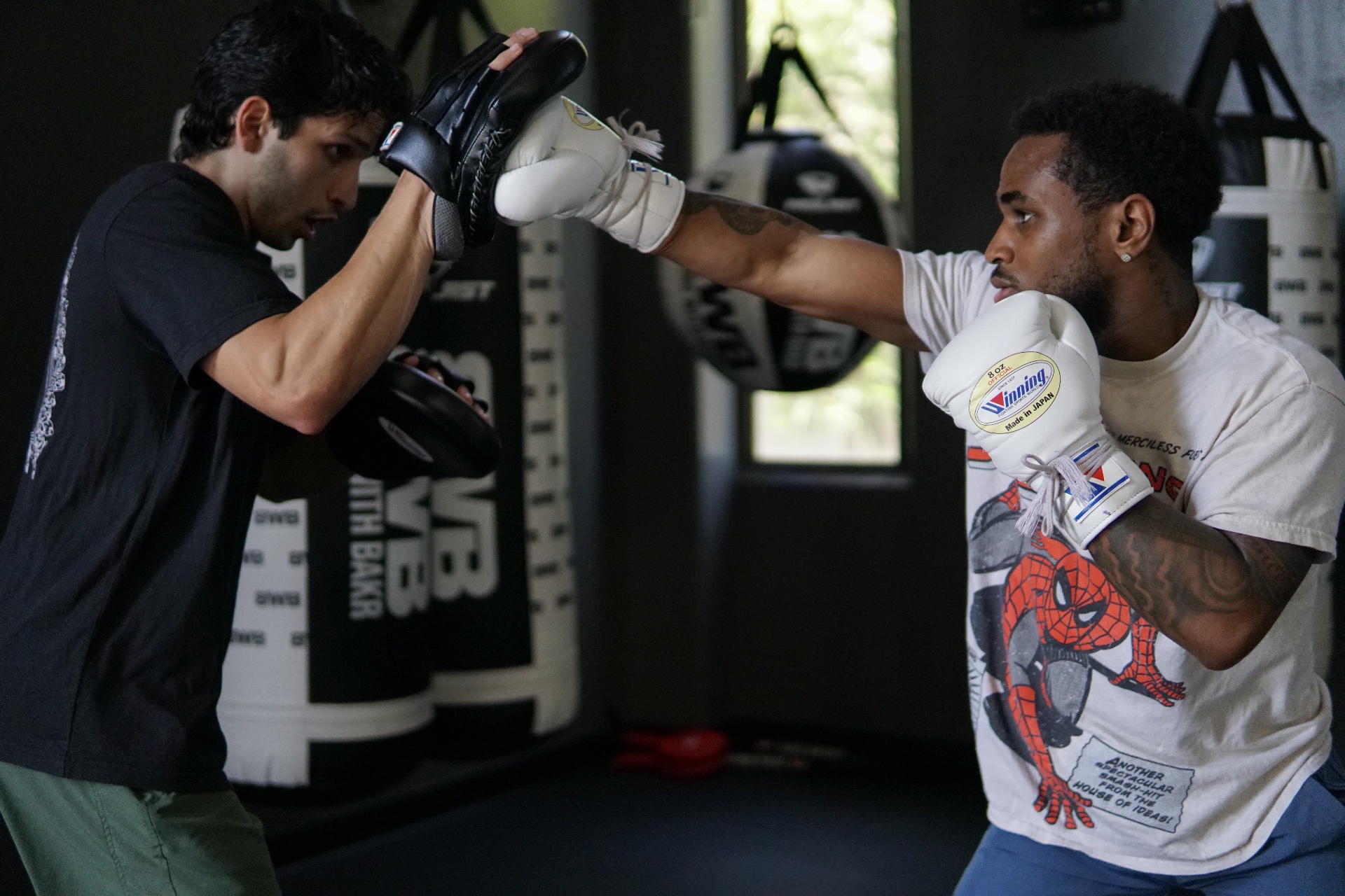 Steve landing a sharp jab on the mitt, full extension